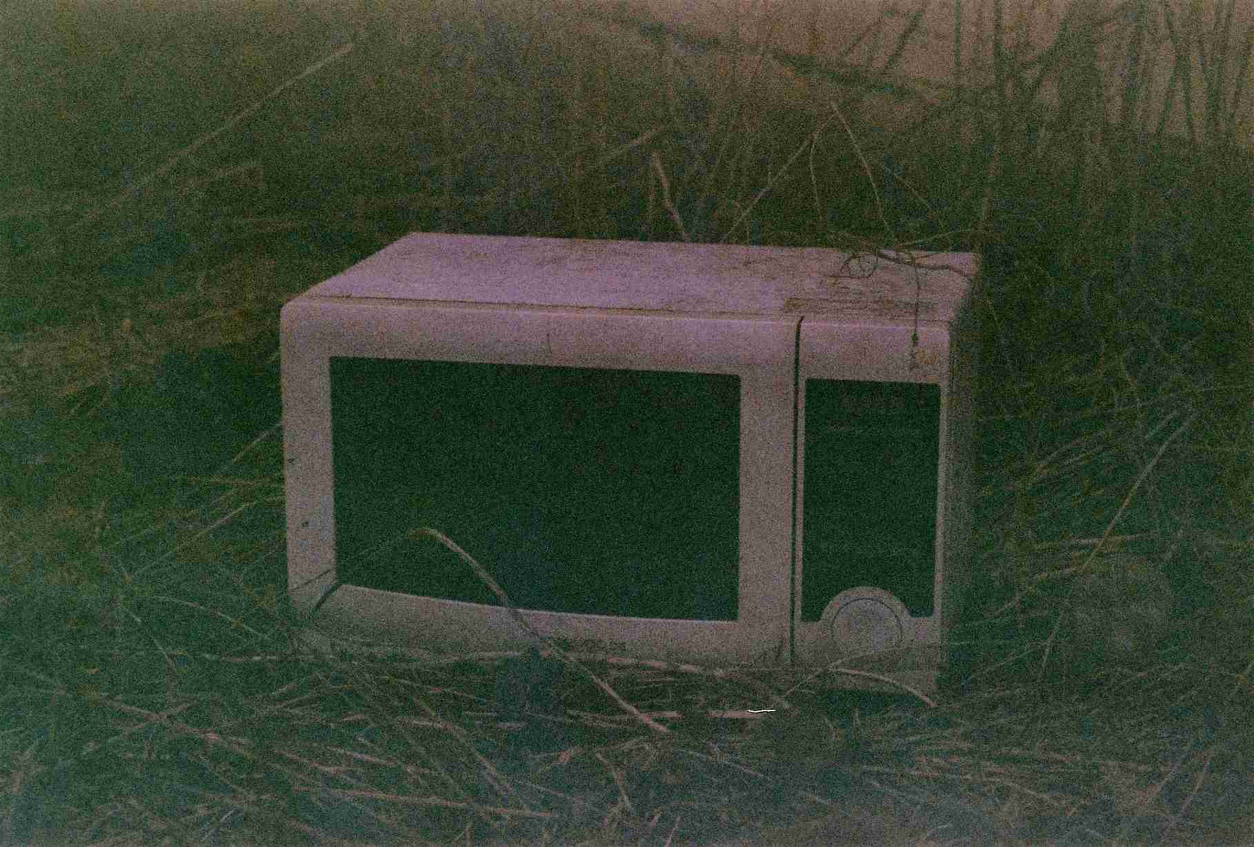 desaturated photo of an abandoned microwave
